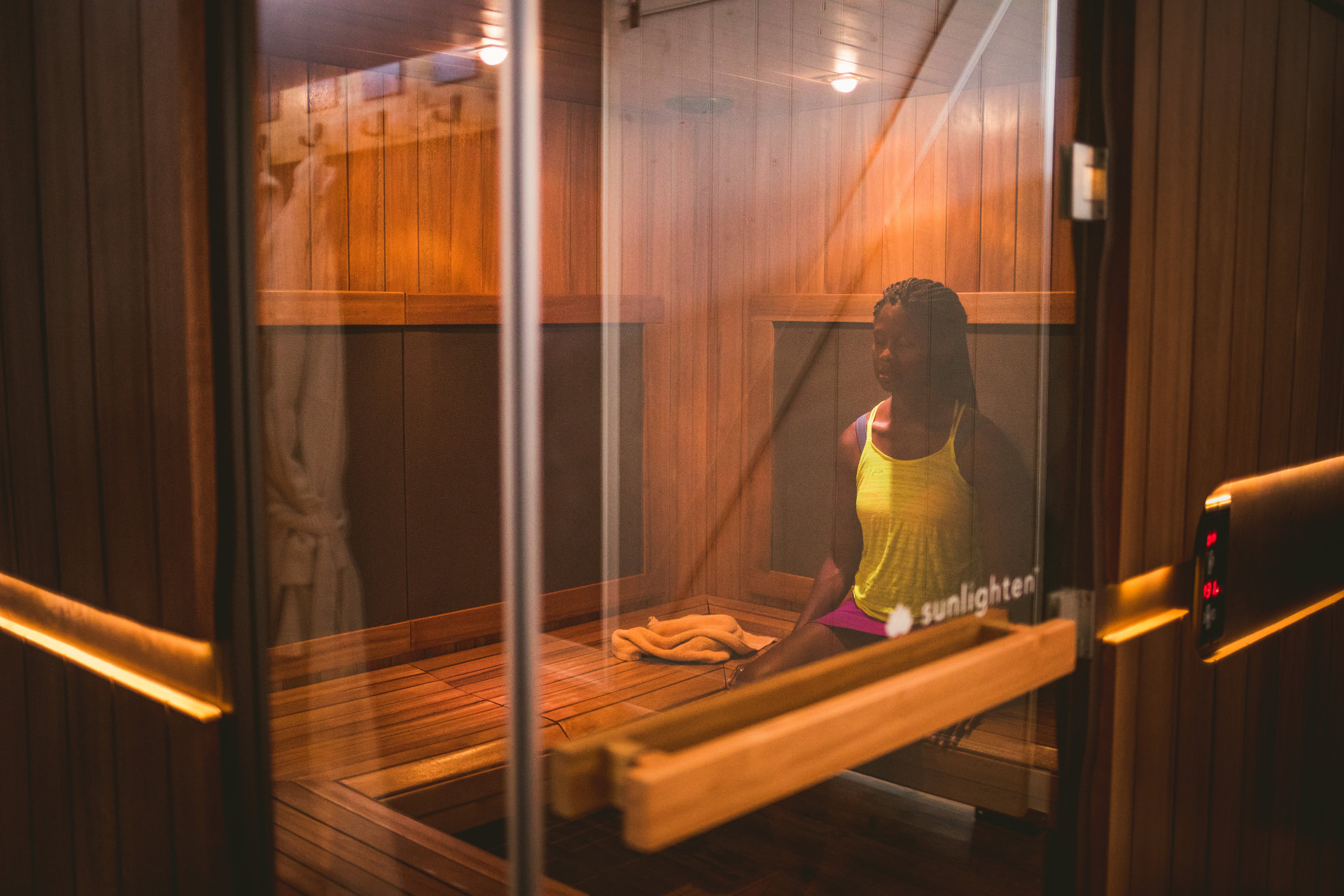 Guest sitting inside a cedar infrared sauna cabin